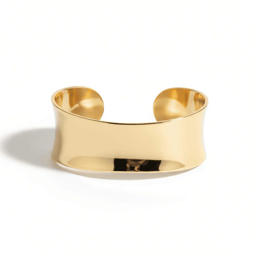 Wide gold plated cuff bracelet with smooth polished finish on white background